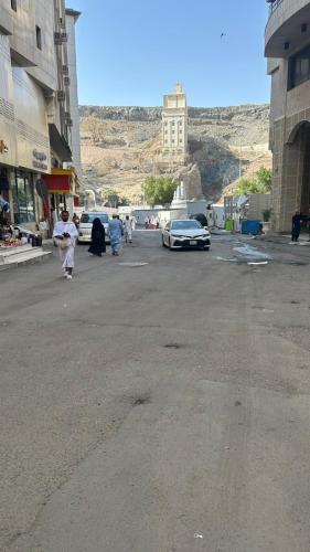 a group of people walking in a parking lot at قاصد الخير in Ajyad