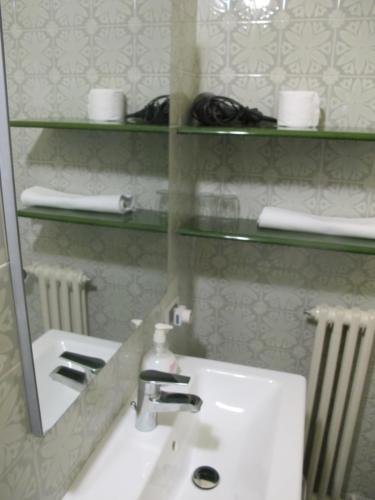 a bathroom with a sink and a mirror at Hotel Conchiglia in Montecatini Terme