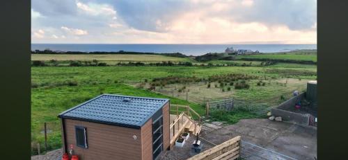 an aerial view of a tiny house in a field at Cnocanreoch Farm Glamping in Kilmory