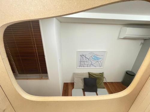 a small room with a couch and a window at Le Cave Troll ル カーブ トロル in Mitaka