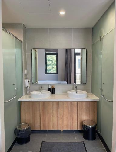 a bathroom with two sinks and a large mirror at Kinh Đô 5 - 20 - 21 in Ðình Loan