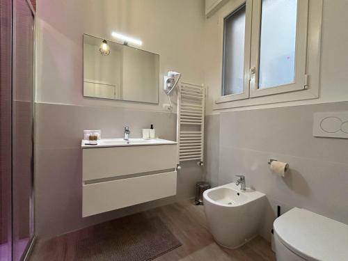 a bathroom with a sink and a toilet and a mirror at 4 Star Bologna Train Station - Self Check-In in Bologna