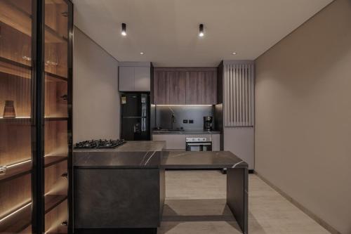 a kitchen with stainless steel appliances and wooden cabinets at Modern & Elegant Loft in El Poblado in Medellín