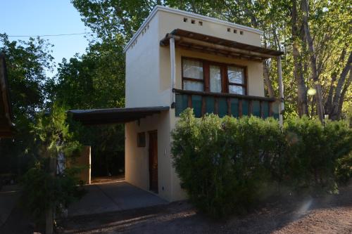 a small house in the middle of a forest at Carü Leufu in Valle Grande