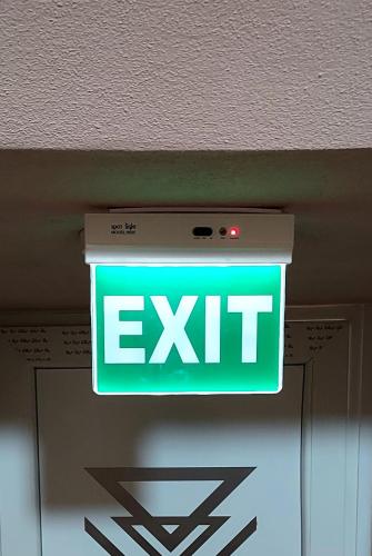 a exit sign hanging from the ceiling of a room at Duba Apartments 2 in Alexandroupoli