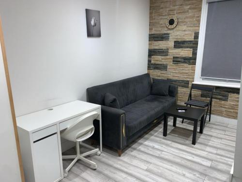 a living room with a couch and a desk at W5 Studio in Ealing