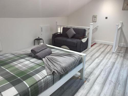 a bedroom with a bed and a chair at W5 Studio in Ealing