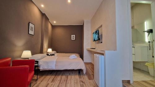 a hotel room with two beds and a red chair at Albergo la Svolta in Brescia
