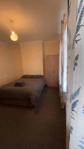 a bedroom with a bed in a room at Guest House Albany Road in Cardiff