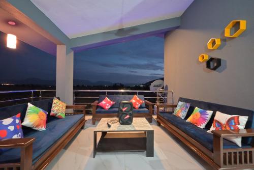 a living room with couches and a table at ll EMPYREAN STAY ll LEONCINO VILLA II 4BHK ll AC ll LARGEST POOL ll in Lonavala