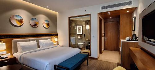 a hotel room with a bed and a bathroom at Charmwood Hotel in Leh
