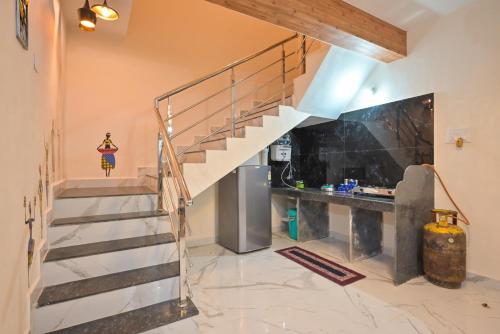 a staircase in a house with a stone floor at ll EMPYREAN STAY ll LEONCINO VILLA II 4BHK ll AC ll LARGEST POOL ll in Lonavala