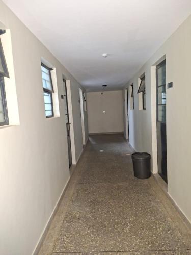 an empty hallway with a trash can in a building at Staycation with Ryn in Ruaka