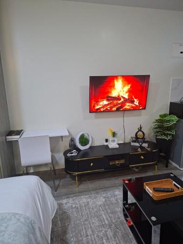 a living room with a fire on the wall at Staycation with Ryn in Ruaka