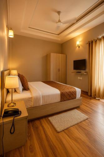 a hotel room with a bed and a television at Hotel Citrine, Vrindavan - A Four Star Luxury Retreat # By Nandan Group # in Vrindāvan
