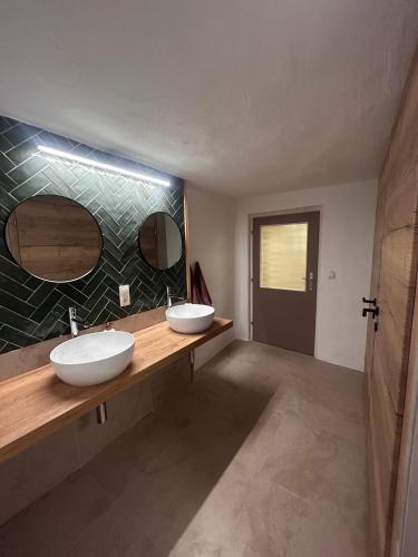 Dos lavabos en un baño con dos espejos en Nynke's AlpenNest, en Arzl im Pitztal