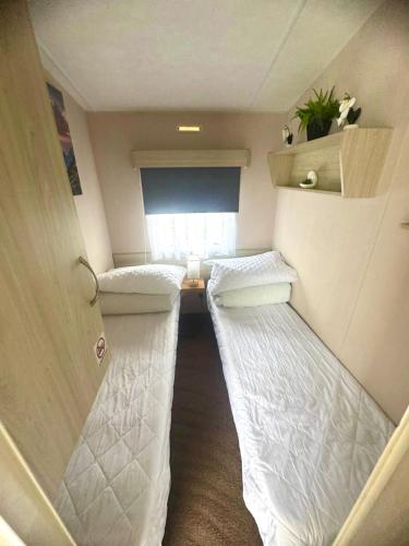 a small room with two beds in a trailer at Lyons Robin Hood , Rhyl in Rhyl