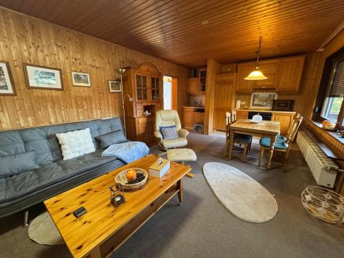 a living room with a couch and a table at Rhönblick Residenz FG in Dipperz