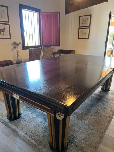 a large wooden table in a room with chairs at Monte do Pombal in Sousel