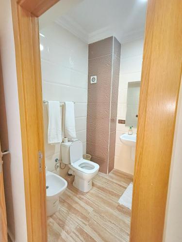a bathroom with a toilet and a sink at les Belles Sejours in Tangier