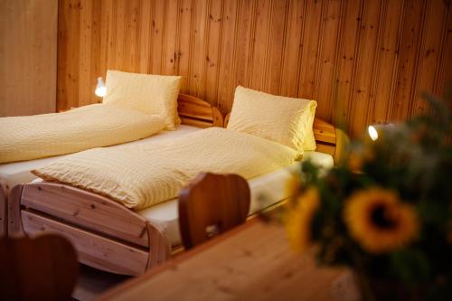 two beds sitting next to each other in a room at Hotel Nufenen in Ulrichen