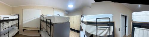 a room with two bunk beds in it at Khan Hostel in Shymkent
