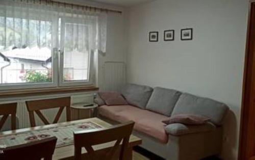 a living room with a couch and a table at Apartmány Grobarčík in Zuberec