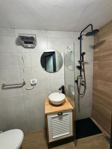 a bathroom with a sink and a mirror at נופש חלומי בכנרת in Tiberias