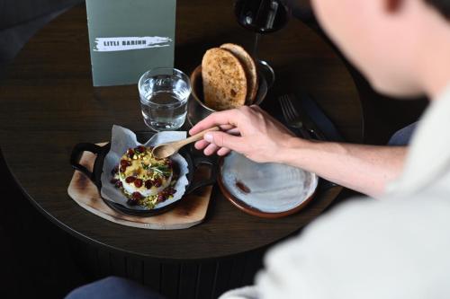 a person sitting at a table with a plate of food at Hotel Local 101 in Reykjavík