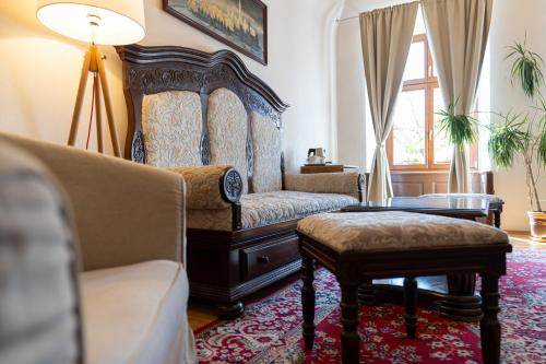 a living room with a couch and a table at Hotel Arkada in Levoča