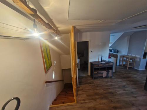 a room with a hallway and a kitchen with a light at Hill Apartment Fischamend in Fischamend Markt