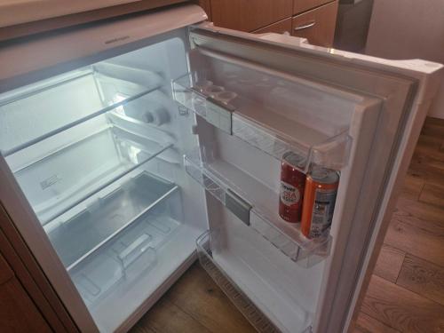 an open refrigerator with its door open in a kitchen at Hill Apartment Fischamend in Fischamend Markt