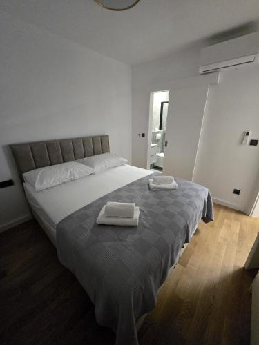 a bedroom with a large bed with two towels on it at Eis in Brodarica