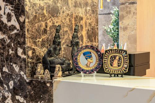 a group of plates sitting on top of a shelf at Pyramids sunrise inn in Cairo