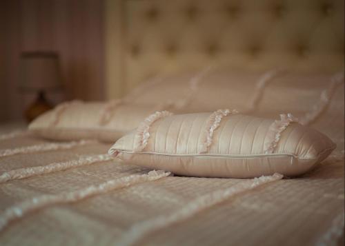 a white pillow sitting on top of a bed at Fazenda in Sumy