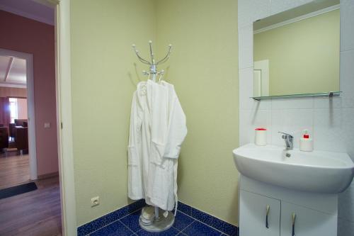 a bathroom with a sink and a towel hanging on a wall at Fazenda in Sumy