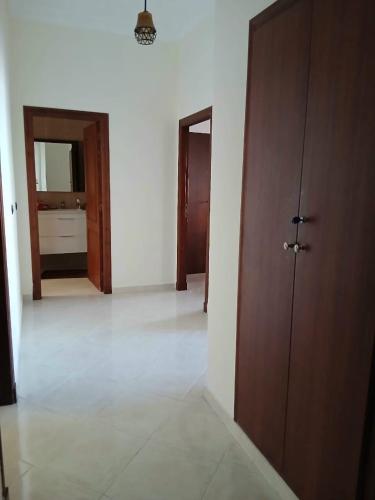 an empty room with a hallway with two doors and a bathroom at Cozy appartement in Tangier in Tangier
