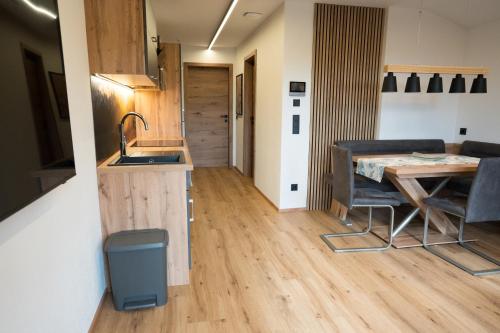 a kitchen and dining room with a table and a sink at Alpenruhe Werfenweng 