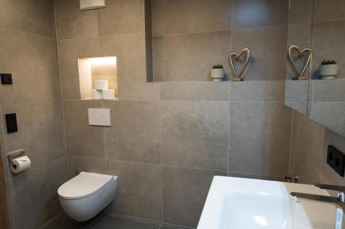 a bathroom with a toilet and a sink at Alpenruhe Werfenweng 