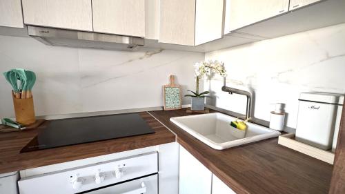 a kitchen with a sink and a counter top at Sunset Oasis on the Beach in Costa Del Silencio