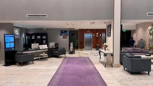 a large lobby with couches and a purple rug at شقق كيان للشقق المخدومة in Abha
