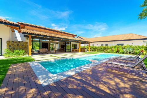 a swimming pool in the backyard of a house at Casa Nimbu - Hacienda Pinilla in Playa Avellana