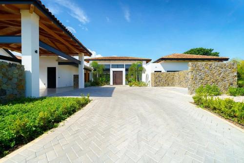 a driveway in front of a house at Casa Nimbu - Hacienda Pinilla in Playa Avellana