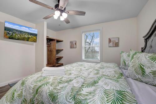 a bedroom with a bed and a ceiling fan at New Lakeview Gateway Lake Access, Hot tub, EV in Lake Harmony
