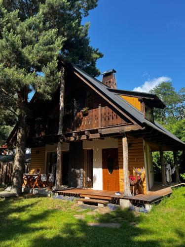 a wooden house with a tower on top of it at Leśna Ostoja 