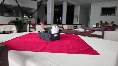 a table with a red napkin and a bottle of wine at Hotel Terra do Sal in Mossoró