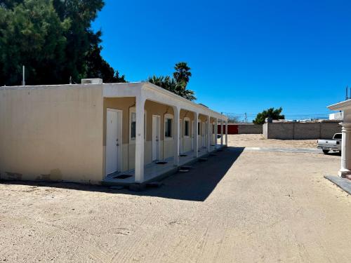 a building that is sitting in a parking lot at Cozy Rooms Near Beach Puerto Peñasco Rocky Point in Puerto Peñasco