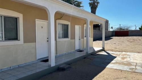 a building with white doors on the side of it at Cozy Rooms Near Beach Puerto Peñasco Rocky Point in Puerto Peñasco