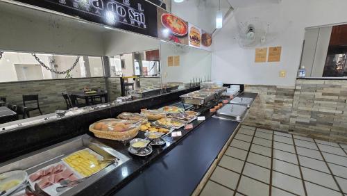 a buffet line in a restaurant with food on it at Hotel Terra do Sal in Mossoró