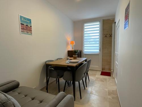a living room with a table and chairs and a couch at MyQuinsac in Quinsac